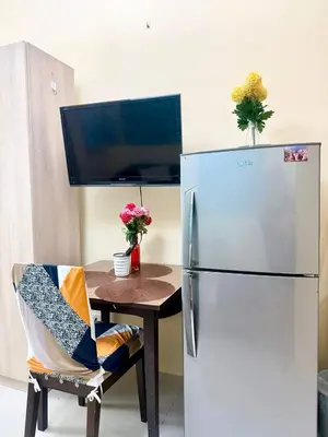 a kitchen with a table and a refrigerator at Sea Residences Tower B Condotel Look F0R MaV in Manila