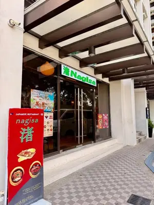 a store front of a restaurant with a sign in front at Mariah Relaxing Minimalist Condo at Filinvest City Alabang in Manila