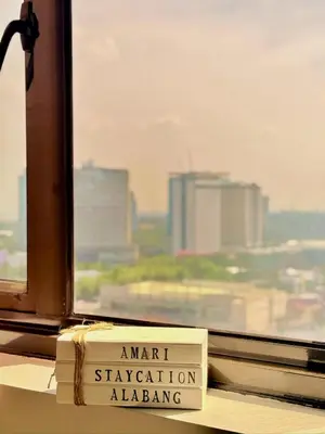 a sign that says amrit stationiddingidding sidx sidx sidx sidx at Mariah Relaxing Minimalist Condo at Filinvest City Alabang in Manila