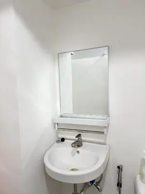a white bathroom with a sink and a mirror at Yakal tanza garden height with Netflix in Tanza