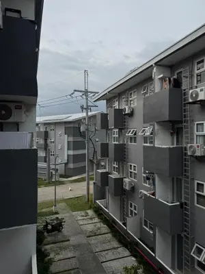 an apartment building with balconies and people looking out the windows at Yakal tanza garden height with Netflix in Tanza