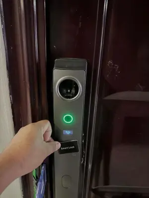 a person holding a green light on a microwave at Yakal tanza garden height with Netflix in Tanza