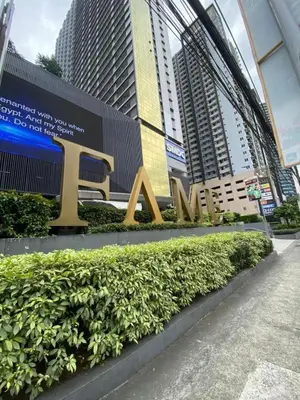 a large sign that says ak in front of buildings at Fame Residences Staycation in Manila