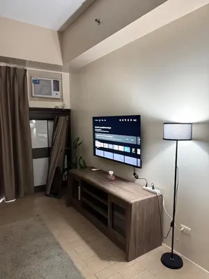 a living room with a flat screen tv on a wall at 81 Newport Across International Airport Terminal 3 C1-7O in Manila