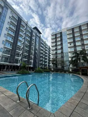 a swimming pool in front of some apartment buildings at 81 Newport Across International Airport Terminal 3 C1-7O in Manila
