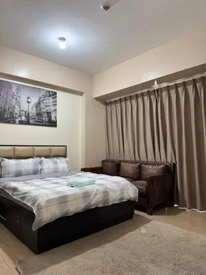 a bedroom with a bed and a couch at 81 Newport Across International Airport Terminal 3 C1-7O in Manila