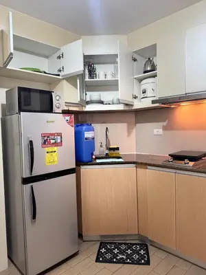 a kitchen with white cabinets and a refrigerator at 81 Newport Across International Airport Terminal 3 C1-7O in Manila