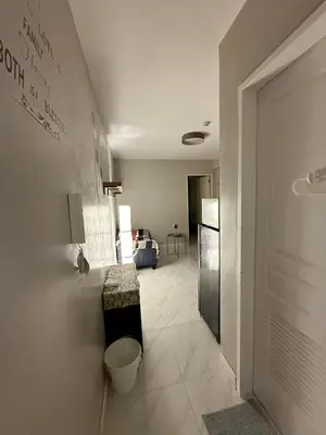 a hallway leading to a living room with a door at 1BR Condo with balcony near MOA,Parqal,Solaire in Manila