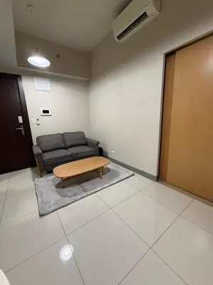 a living room with a couch and a coffee table at Condo in BGC by MichVist - Uptown Parksuites Tower 2 in Manila