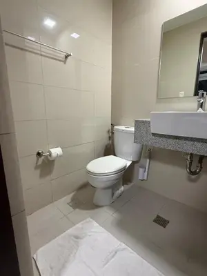 a bathroom with a toilet and a sink at Condo in BGC by MichVist - Uptown Parksuites Tower 2 in Manila