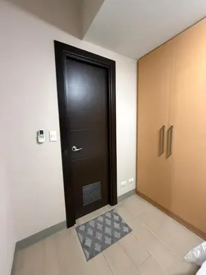 a black door with a rug in a room at Condo in BGC by MichVist - Uptown Parksuites Tower 2 in Manila
