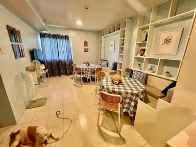 a dog is laying on the floor in a living room at Jin's Jaunt in Manila