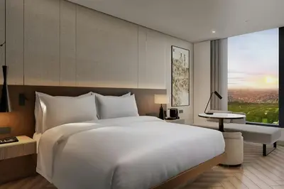 a bedroom with a large white bed and a window at AC Hotel by Marriott Manila in Manila