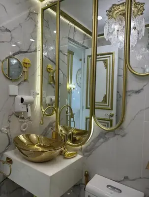 a bathroom with two sinks and a large mirror at Royal Studio in Manila