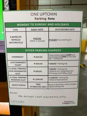 a sign for a parking rate at a parking garage at Elegant BGC 1BR Staycation One Uptown Residence in Manila