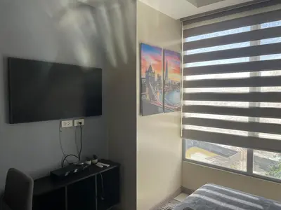 a room with a flat screen tv and a window at Comfy Studio for 2 at Sunshine100 in Mandaluyong Fully equipped in Manila