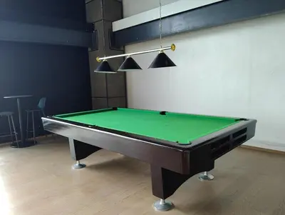 a pool table in a room with a green at Elements Residences 1br fully furnished with balcony in Manila