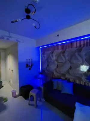 a living room with a couch and blue lights at Sea Residences Serenity in Manila