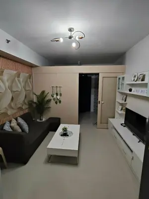 a living room with a couch and a table at Sea Residences Serenity in Manila