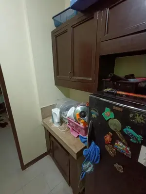 a kitchen with a black refrigerator and a counter at Ben's stay cation in Manila
