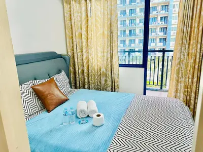 a bedroom with a bed with towels and a window at Rooms near Aiport - Credit Card accepted 0995 - 448 - 8872 in Manila