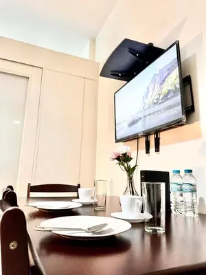 a table with plates and a television on a wall at Rooms near Aiport - Credit Card accepted 0995 - 448 - 8872 in Manila