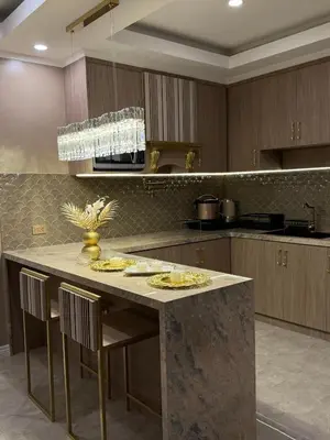 a kitchen with a table with chairs and a counter top at Pure Elegance 1BR Suite in Manila