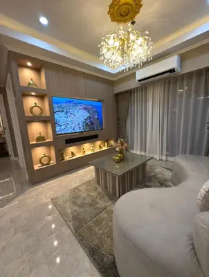 a living room with a couch and a tv at Pure Elegance 1BR Suite in Manila