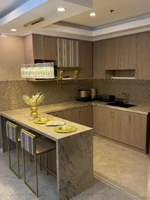 a kitchen with a large island with a counter top at Pure Elegance 1BR Suite in Manila