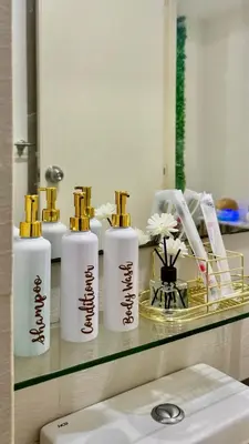 a shelf with three bottles ofodorizers on a bathroom counter at Azure Urban Resort Residences, 1BR Bahamas 15th floor in Manila