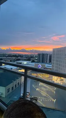 a view of a city at sunset from a building at Azure Urban Resort Residences, 1BR Bahamas 15th floor in Manila