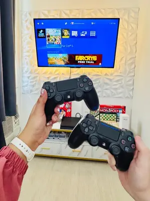 a person holding a video game controller in front of a tv at Azure Urban Resort Residences, 1BR Bahamas 15th floor in Manila