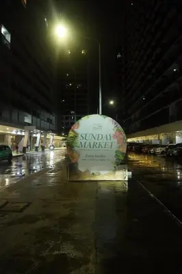 a sign for a sundial market in a parking lot at night at Modern Staycation near MOA & NAIA with PS4, Netflix, Wi-Fi in Manila