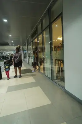 a group of people standing in front of a store at Modern Staycation near MOA & NAIA with PS4, Netflix, Wi-Fi in Manila