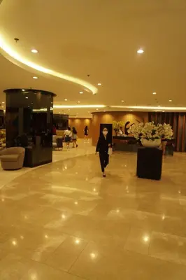a man walking through a lobby of a building at Modern Staycation near MOA & NAIA with PS4, Netflix, Wi-Fi in Manila