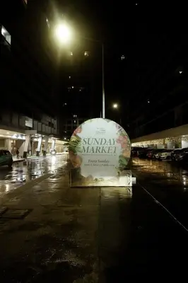 a sign in the middle of a parking lot at night at Pool View Condo near NAIA, SMX Netflix, WiFi, PS4 in Manila
