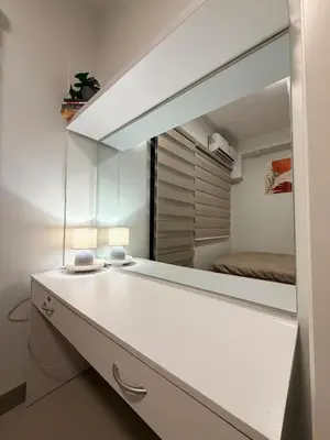 a bedroom with a mirror and a bed in a room at Pool View Condo near NAIA, SMX Netflix, WiFi, PS4 in Manila