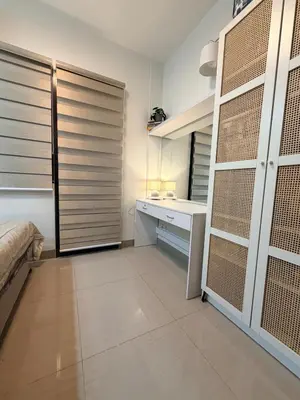 a bedroom with a bed and a desk and a closet at Pool View Condo near NAIA, SMX Netflix, WiFi, PS4 in Manila