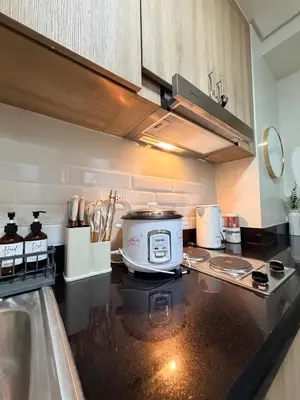 a kitchen with a counter top with a toaster on it at Pool View Condo near NAIA, SMX Netflix, WiFi, PS4 in Manila