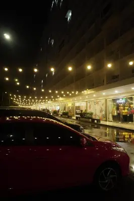a car parked in front of a building at night at City View Near MOA & NAIA with PS4, Wi-Fi, Netflix in Manila