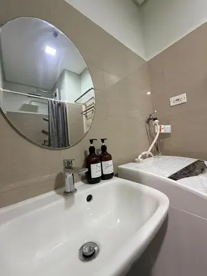 a bathroom with a white sink and a mirror at City View Near MOA & NAIA with PS4, Wi-Fi, Netflix in Manila