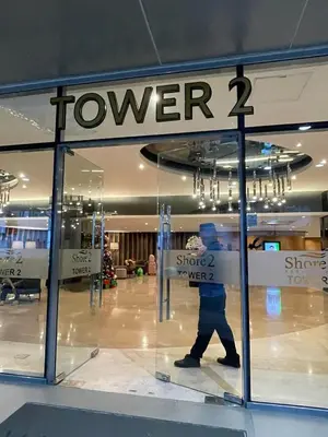 a man walking past a window of a store at Cozy Haven Staycation in Manila