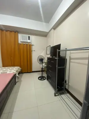 a room with a bedroom with a bed and a television at Alliyah staycation newport101 near naia terminal 3 in Manila
