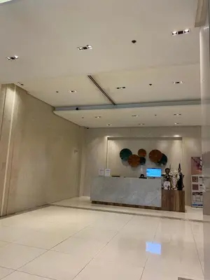 a lobby with a reception desk in a building at Alliyah staycation newport101 near naia terminal 3 in Manila