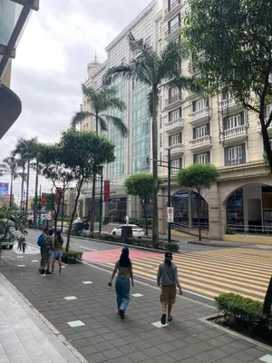a group of people walking down a city street at Alliyah staycation newport101 near naia terminal 3 in Manila