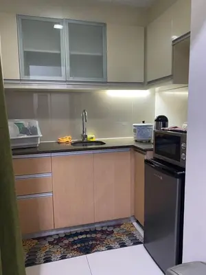 a kitchen with a sink and a microwave at Alliyah staycation newport101 near naia terminal 3 in Manila