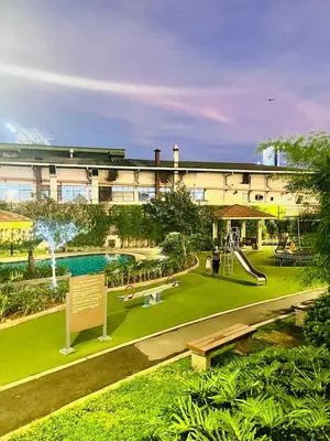 a building with a park with a slide and a playground at Chill Escape Prisma near BGC and Ortigas in Manila