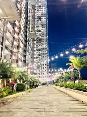 a city street at night with tall buildings at Chill Escape Prisma near BGC and Ortigas in Manila