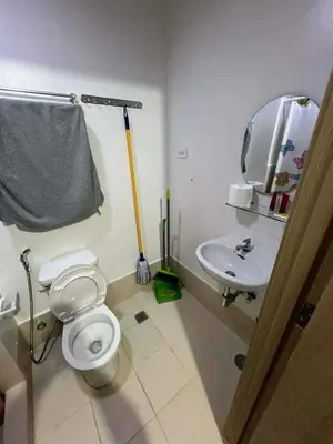 a bathroom with a toilet and a sink at Transient Home by Molave in Manila
