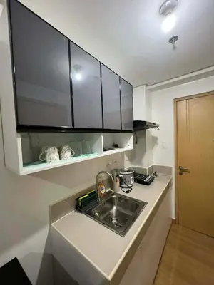 a kitchen with a sink and a counter top at Transient Home by Molave in Manila